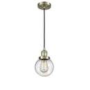 Beacon Mini Pendant shown in the Antique Brass finish with a Seedy shade