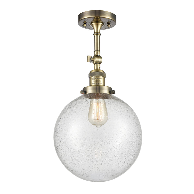 Beacon Semi-Flush Mount shown in the Antique Brass finish with a Seedy shade