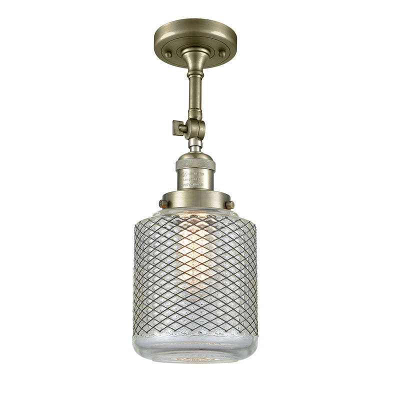 Stanton Semi-Flush Mount shown in the Antique Brass finish with a Clear Wire Mesh shade