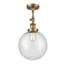 Beacon Semi-Flush Mount shown in the Brushed Brass finish with a Seedy shade