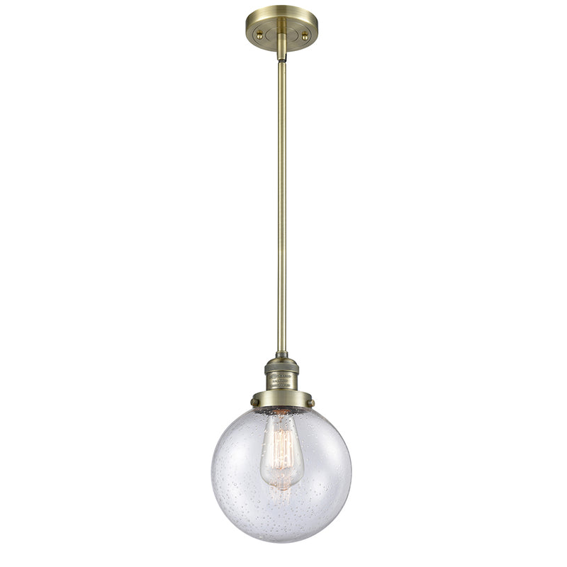 Beacon Mini Pendant shown in the Antique Brass finish with a Seedy shade