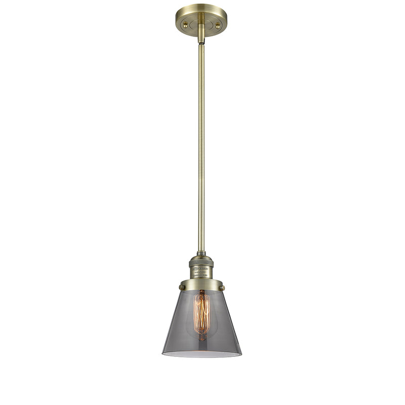 Cone Mini Pendant shown in the Antique Brass finish with a Plated Smoke shade