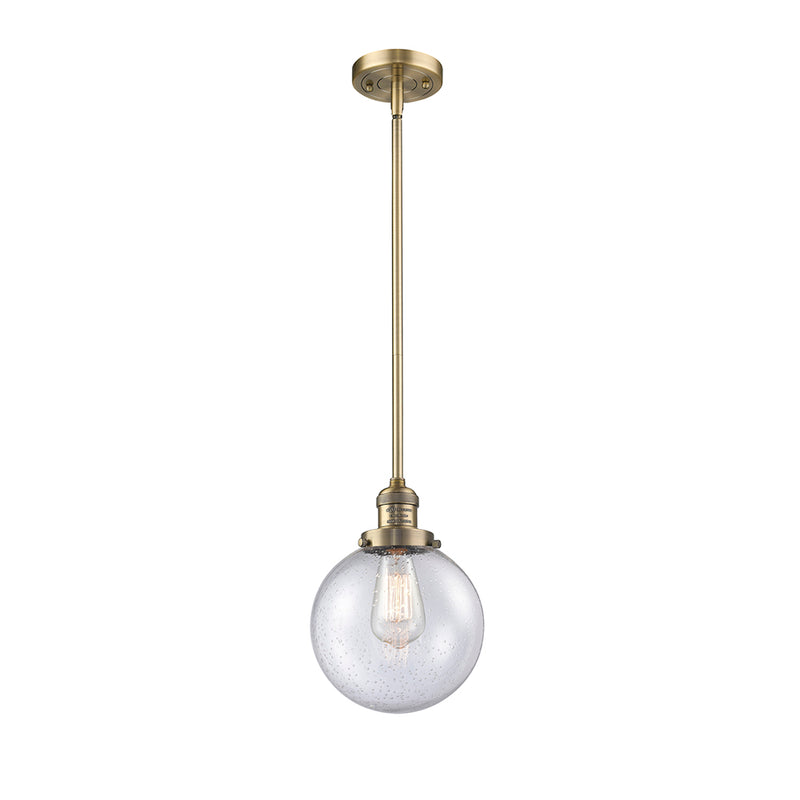 Beacon Mini Pendant shown in the Brushed Brass finish with a Seedy shade