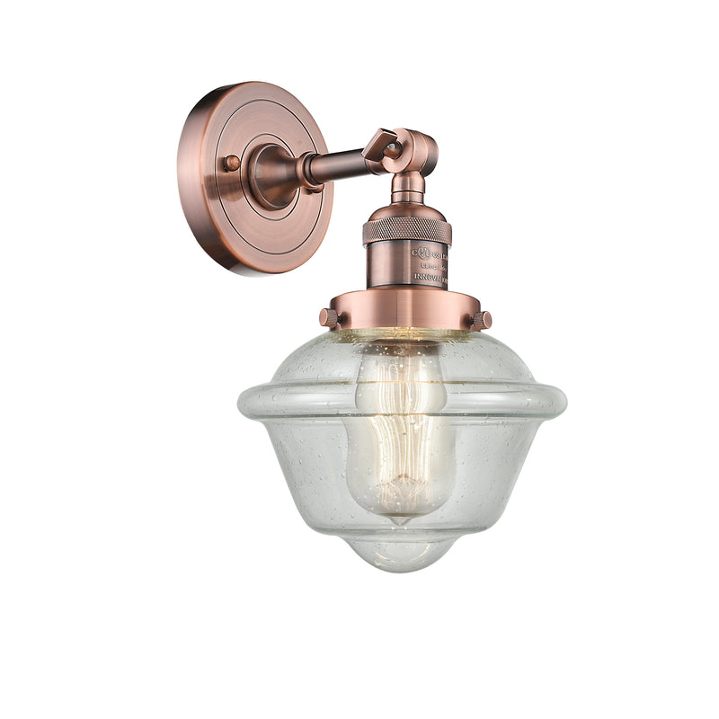 Oxford Sconce shown in the Antique Copper finish with a Seedy shade