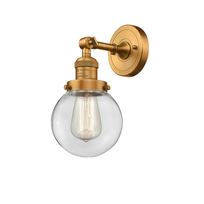 Beacon Sconce shown in the Brushed Brass finish with a Clear shade