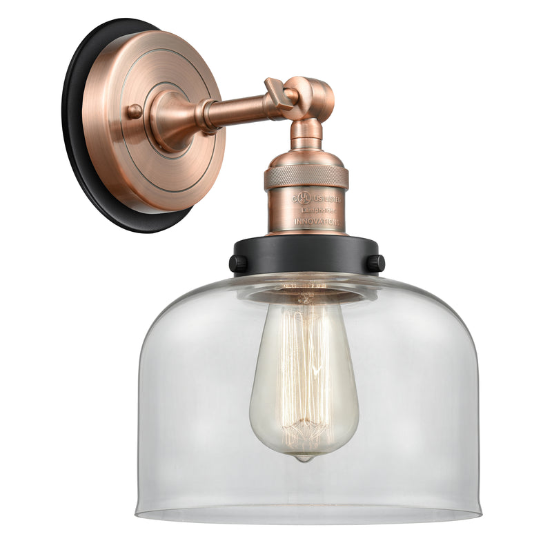 Bell Sconce shown in the Antique Copper finish with a Clear shade