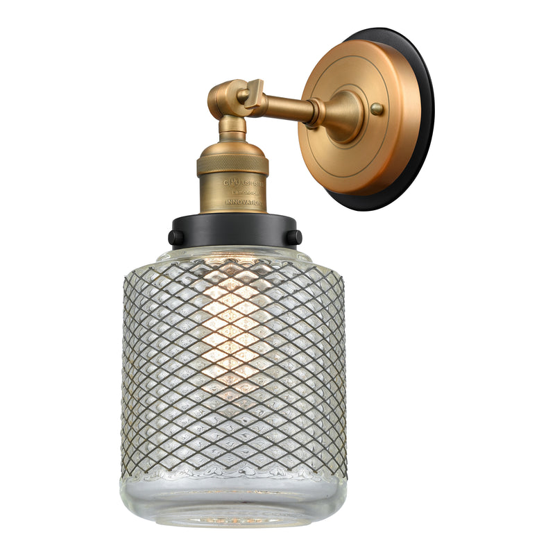 Stanton Sconce shown in the Brushed Brass finish with a Clear Wire Mesh shade