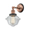 Oxford Sconce shown in the Antique Copper finish with a Clear shade