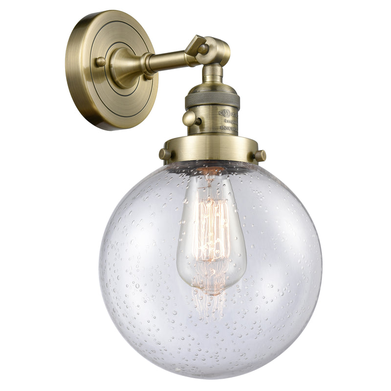 Beacon Sconce shown in the Antique Brass finish with a Seedy shade