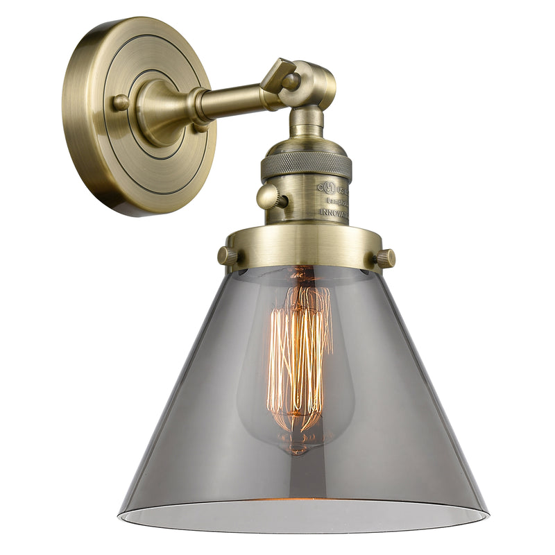 Cone Sconce shown in the Antique Brass finish with a Plated Smoke shade