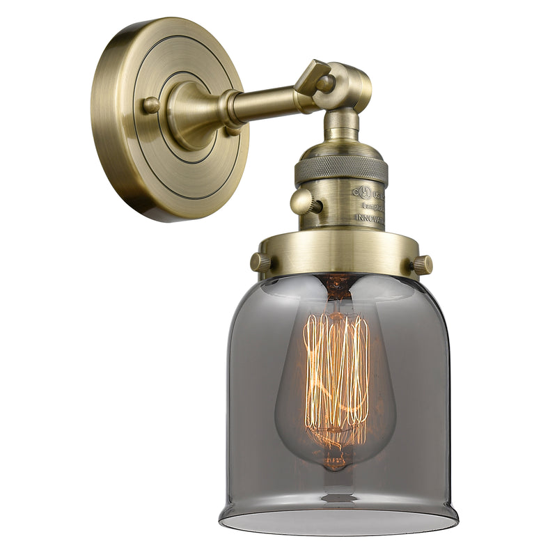 Bell Sconce shown in the Antique Brass finish with a Plated Smoke shade