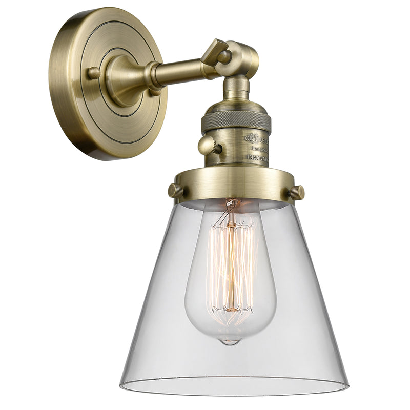 Cone Sconce shown in the Antique Brass finish with a Clear shade