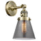 Cone Sconce shown in the Antique Brass finish with a Plated Smoke shade