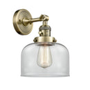 Bell Sconce shown in the Antique Brass finish with a Clear shade