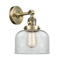 Innovations Lighting Large Bell 1-100 watt 8 inch Antique Brass Sconce with Clear glass and Solid Brass 180 Degree Adjustable Swivel With Engraved Cast Cup Includes a "High-Low-Off" Switch. 203SWABG72