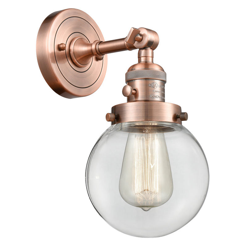 Beacon Sconce shown in the Antique Copper finish with a Clear shade