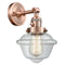 Oxford Sconce shown in the Antique Copper finish with a Clear shade