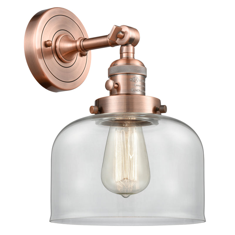 Bell Sconce shown in the Antique Copper finish with a Clear shade