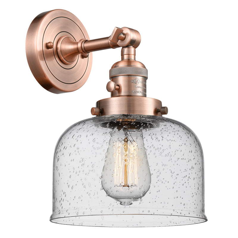 Bell Sconce shown in the Antique Copper finish with a Seedy shade