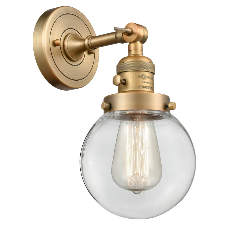 Beacon Sconce shown in the Brushed Brass finish with a Clear shade