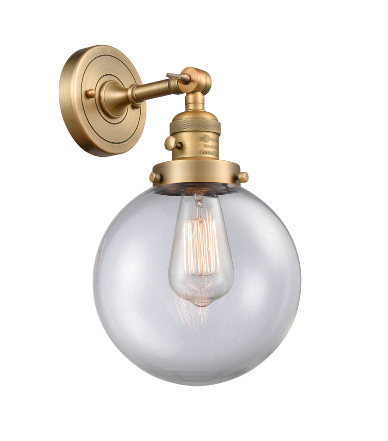 Innovations Lighting Beacon 1-100 watt 8 inch Brushed Brass Sconce with Clear glass and Solid Brass 180 Degree Adjustable Swivel With Engraved Cast Cup Includes a "High-Low-Off" Switch. 203SWBBG2028