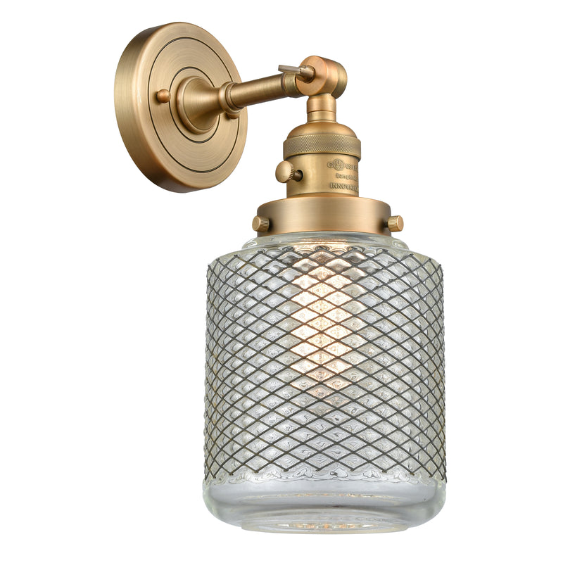 Stanton Sconce shown in the Brushed Brass finish with a Clear Wire Mesh shade