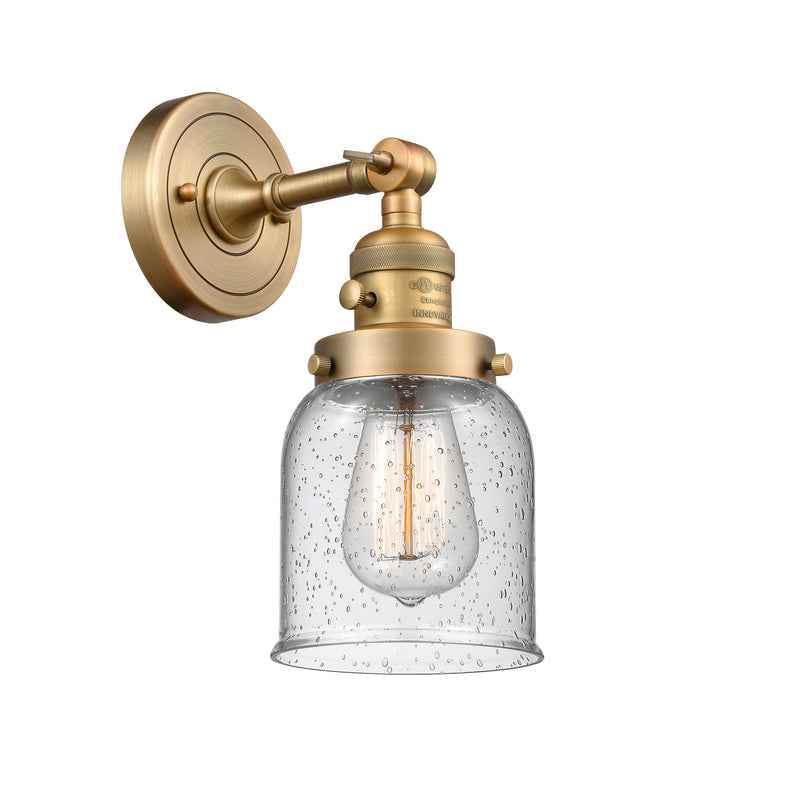 Innovations Lighting Small Bell 1-100 watt 5 inch Brushed Brass Sconce with Seedy glass and Solid Brass 180 Degree Adjustable Swivel With Engraved Cast Cup Includes a "High-Low-Off" Switch. 203SWBBG54