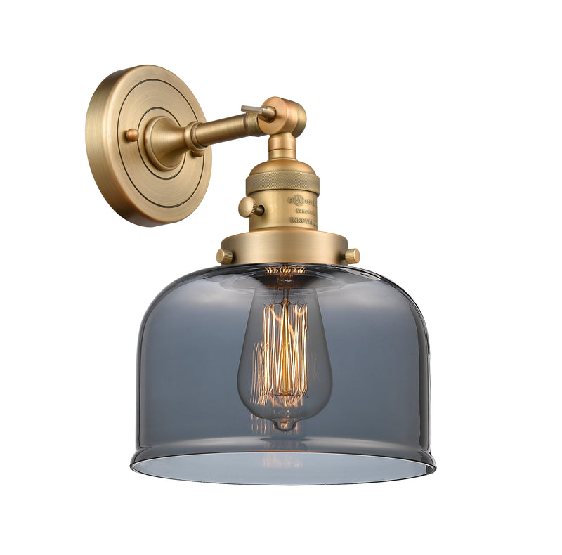 Innovations Lighting Large Bell 1-100 watt 8 inch Brushed Brass Sconce with Smoked glass and Solid Brass 180 Degree Adjustable Swivel With Engraved Cast Cup Includes a "High-Low-Off" Switch. 203SWBBG73