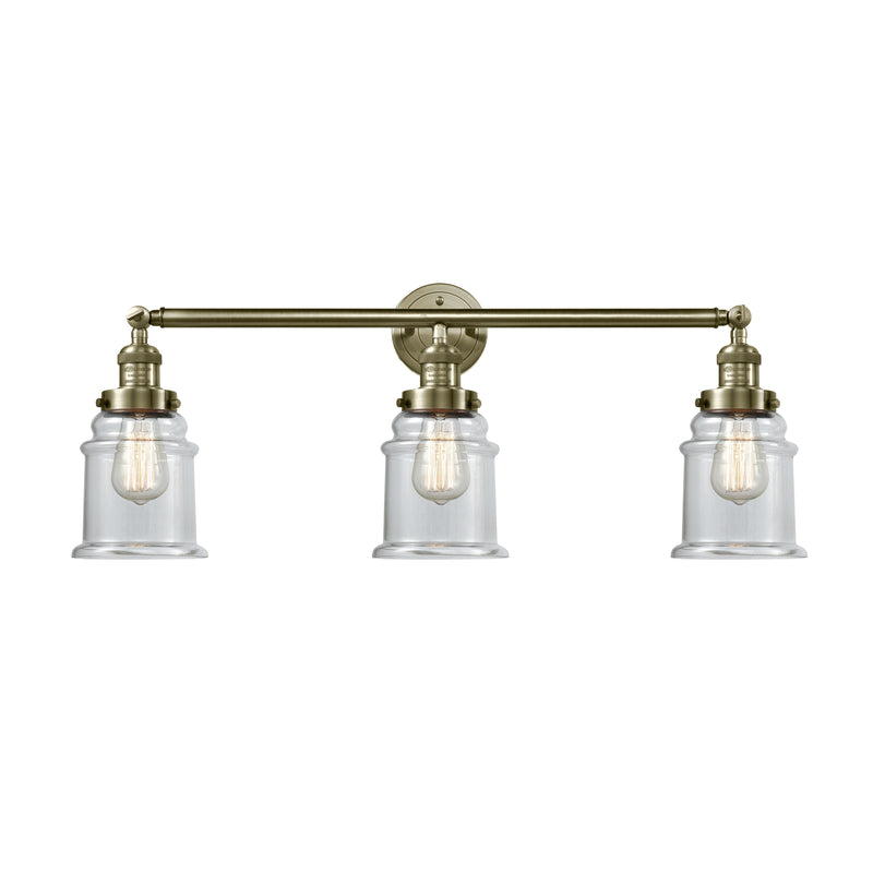 Canton Bath Vanity Light shown in the Antique Brass finish with a Clear shade
