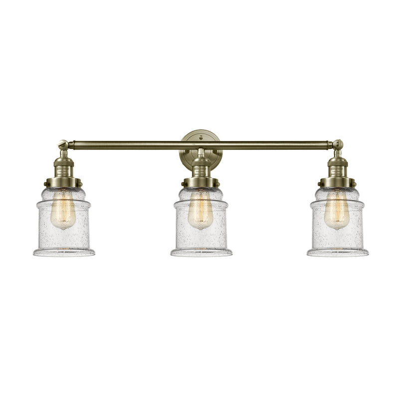 Canton Bath Vanity Light shown in the Antique Brass finish with a Seedy shade
