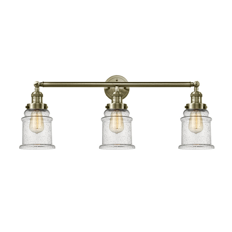Canton Bath Vanity Light shown in the Antique Brass finish with a Seedy shade
