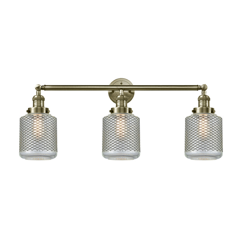 Stanton Bath Vanity Light shown in the Antique Brass finish with a Clear Wire Mesh shade