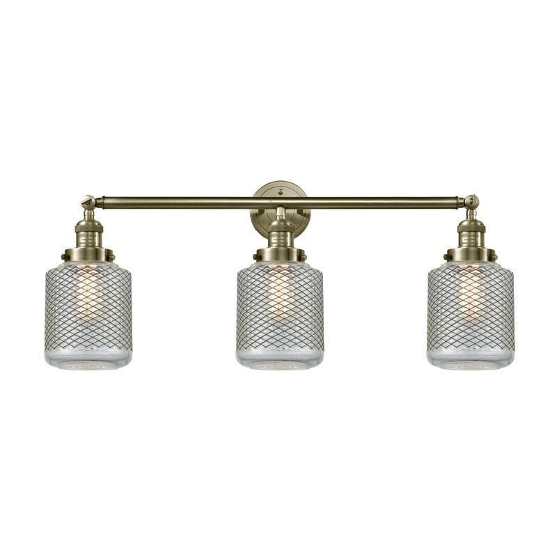 Stanton Bath Vanity Light shown in the Antique Brass finish with a Clear Wire Mesh shade