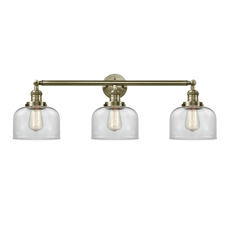 Bell Bath Vanity Light shown in the Antique Brass finish with a Clear shade