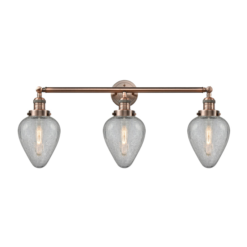 Geneseo Bath Vanity Light shown in the Antique Copper finish with a Clear Crackled shade