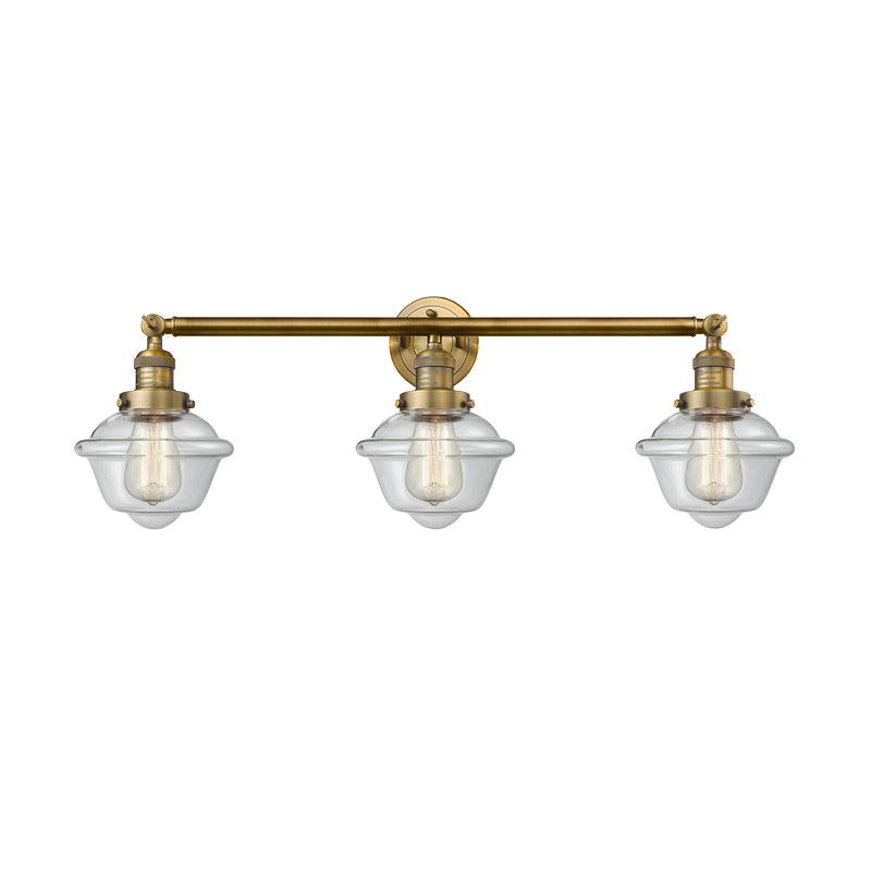Oxford Bath Vanity Light shown in the Brushed Brass finish with a Clear shade