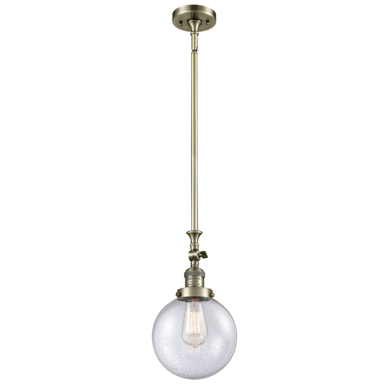 Beacon Mini Pendant shown in the Antique Brass finish with a Seedy shade