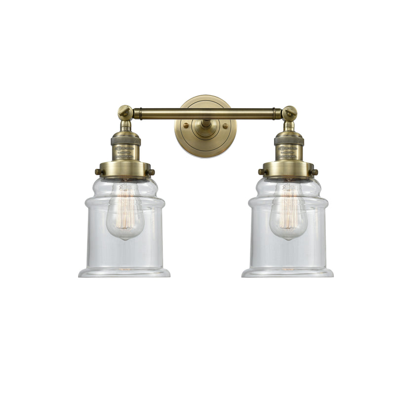 Canton Bath Vanity Light shown in the Antique Brass finish with a Clear shade