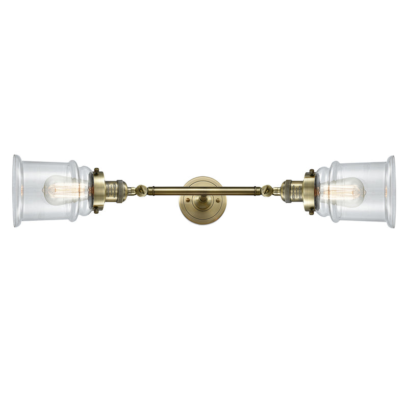 Canton Bath Vanity Light shown in the Antique Brass finish with a Clear shade