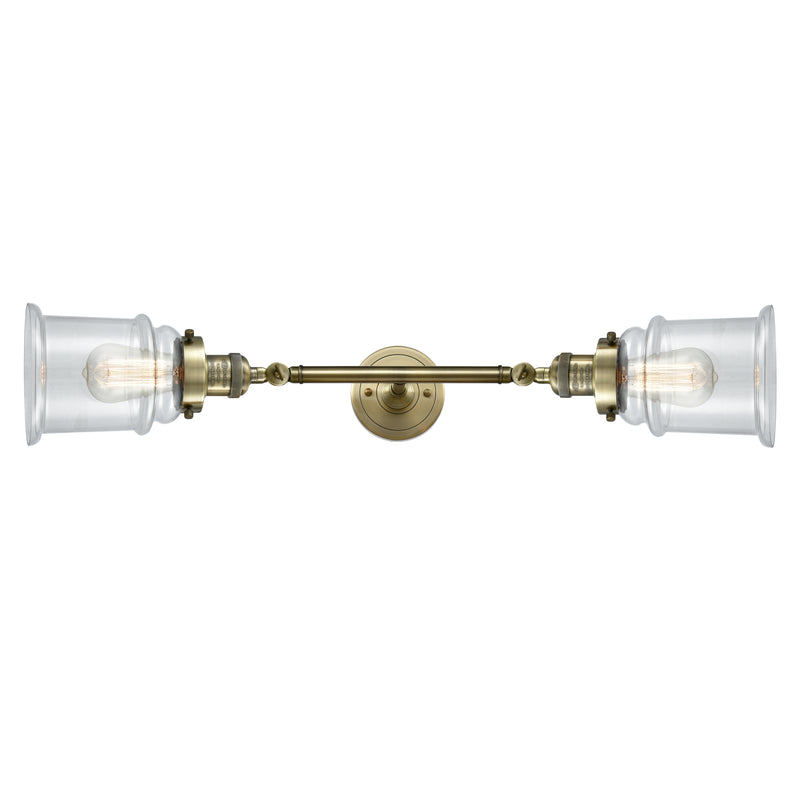 Canton Bath Vanity Light shown in the Antique Brass finish with a Clear shade