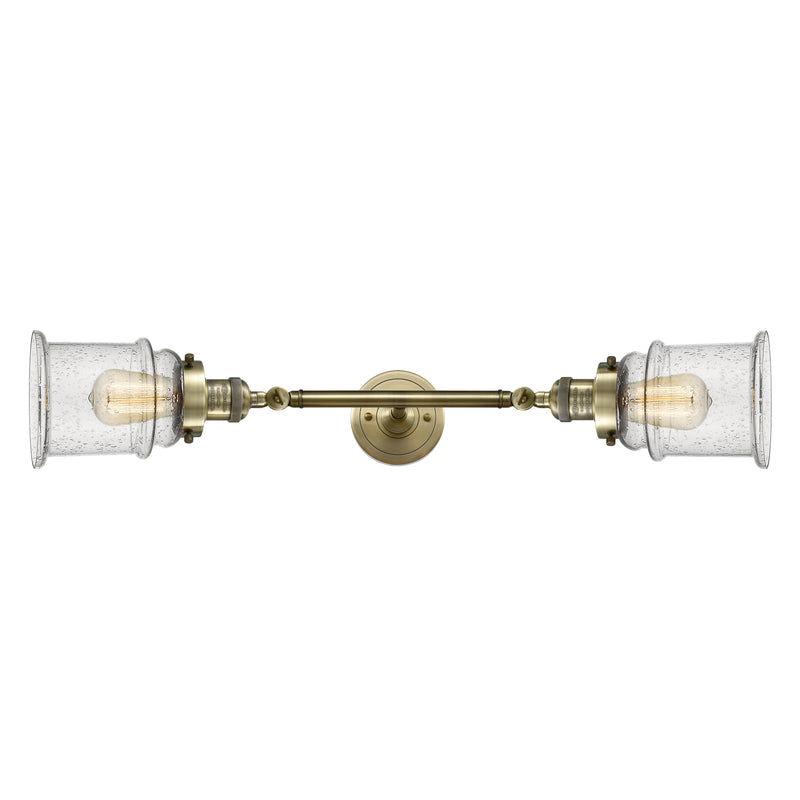 Canton Bath Vanity Light shown in the Antique Brass finish with a Seedy shade