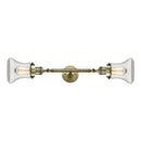 Bellmont Bath Vanity Light shown in the Antique Brass finish with a Clear shade