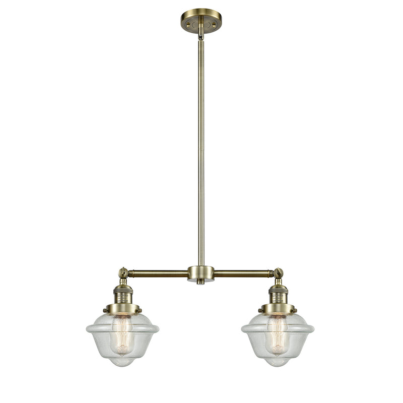 Oxford Island Light shown in the Antique Brass finish with a Seedy shade