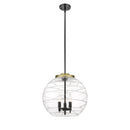 Deco Swirl Pendant shown in the Black Antique Brass finish with a Clear shade