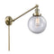 Beacon Swing Arm shown in the Antique Brass finish with a Clear shade