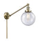 Beacon Swing Arm shown in the Antique Brass finish with a Seedy shade