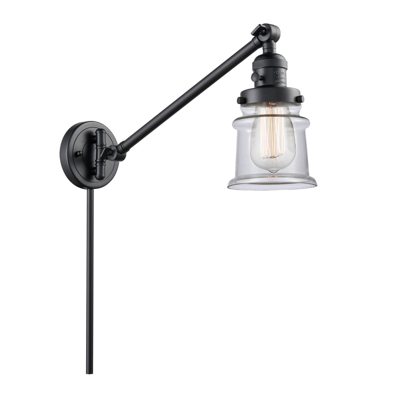 Canton Swing Arm shown in the Matte Black finish with a Clear shade