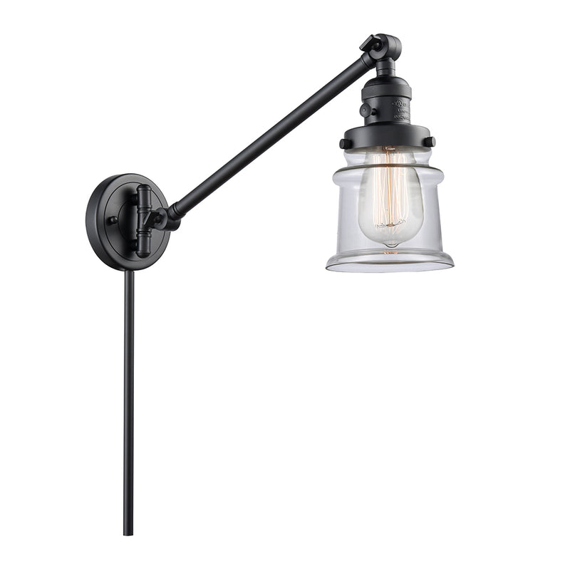 Canton Swing Arm shown in the Matte Black finish with a Clear shade