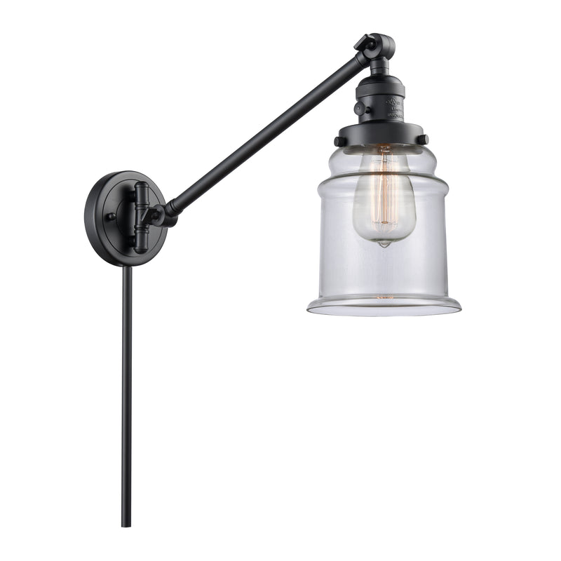 Canton Swing Arm shown in the Matte Black finish with a Clear shade