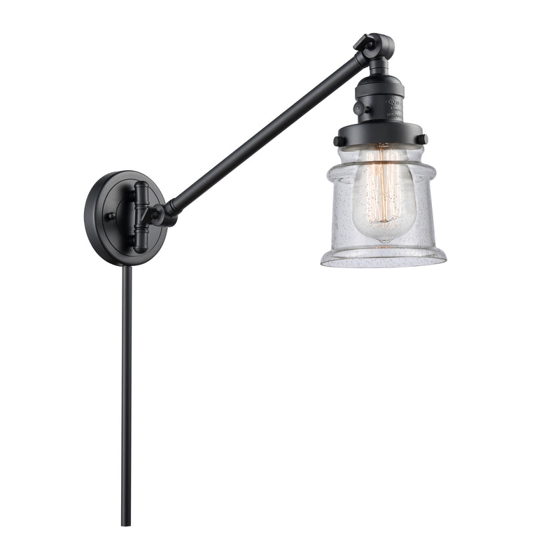 Canton Swing Arm shown in the Matte Black finish with a Seedy shade